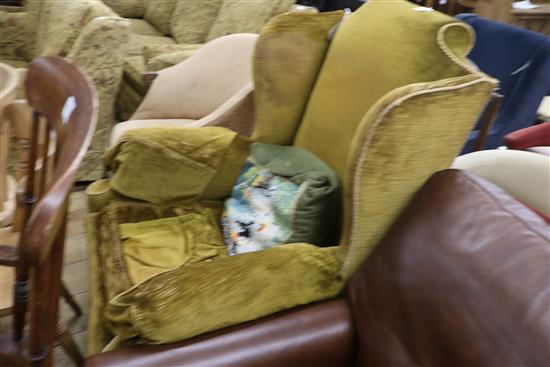 A Georgian style wing back armchair with gold upholstery